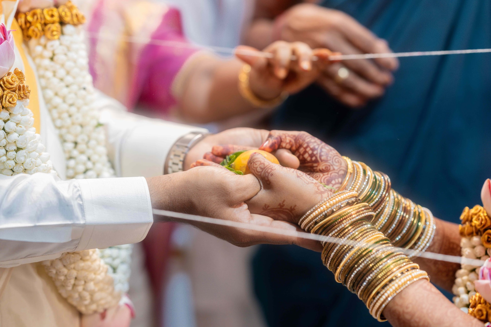 Candid videography in Chennai capturing a bride and groom during a wedding ritual, with professional microphones ensuring crystal-clear audio of vows and blessings