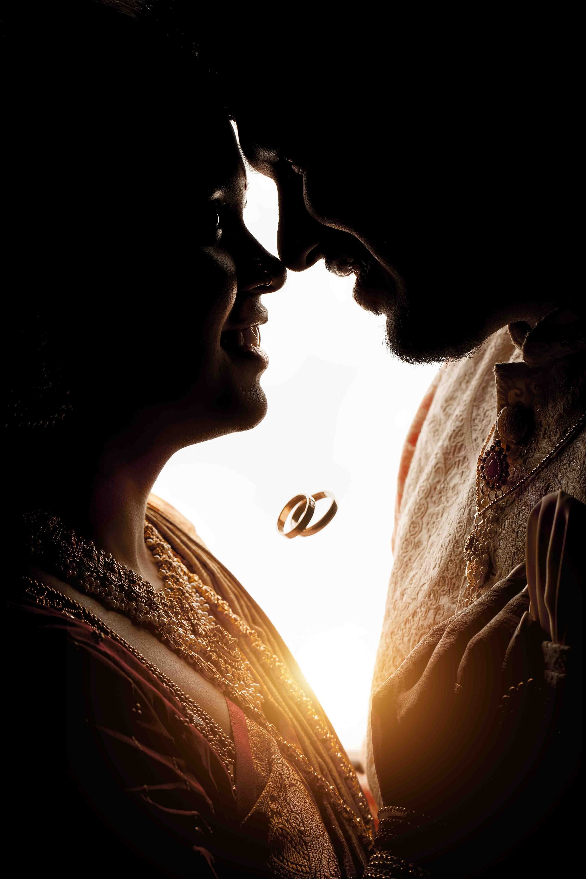 Silhouette of couple with wedding rings