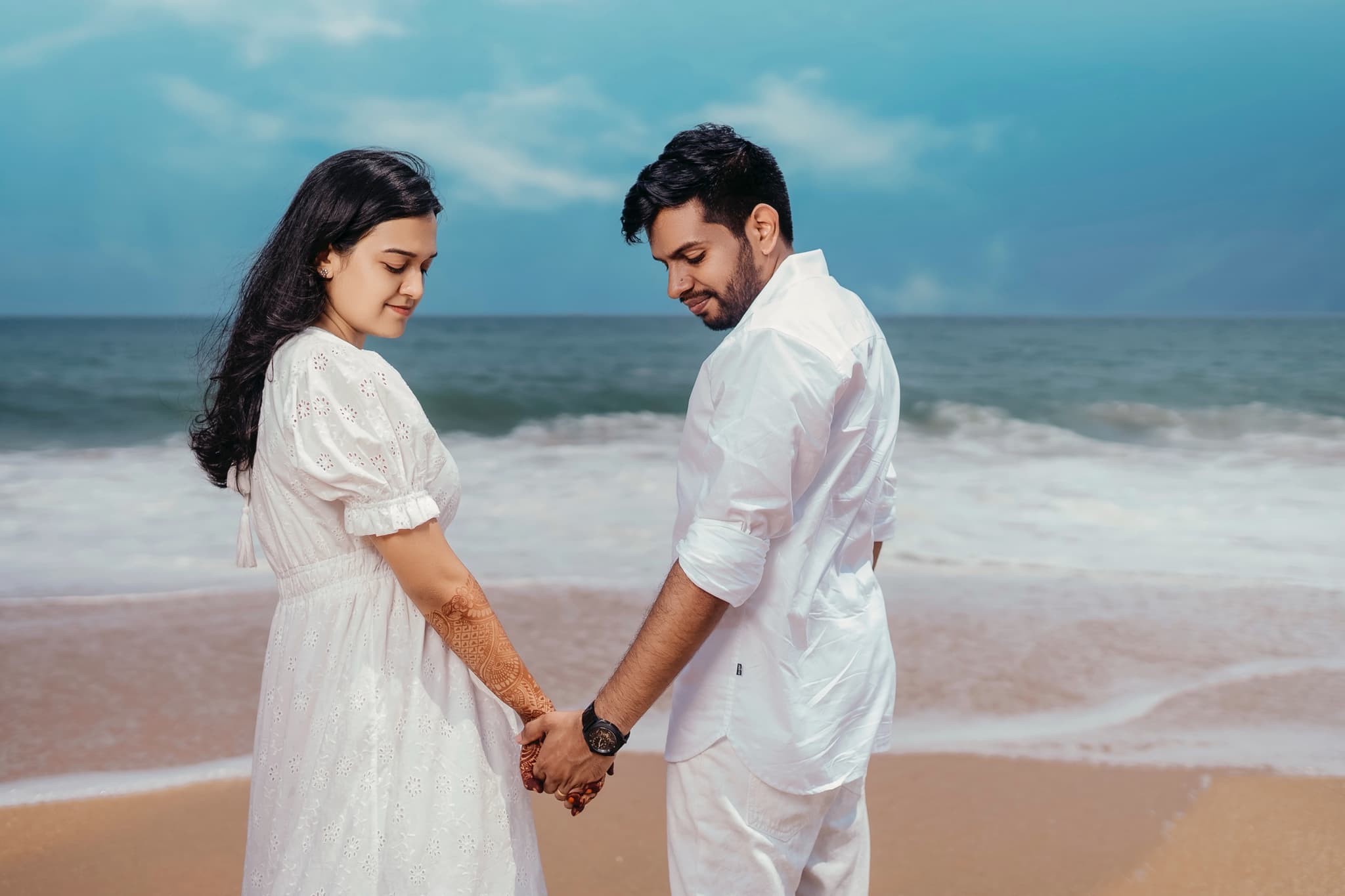 Couple enjoying a romantic moment at the beach during their post-wedding shoot