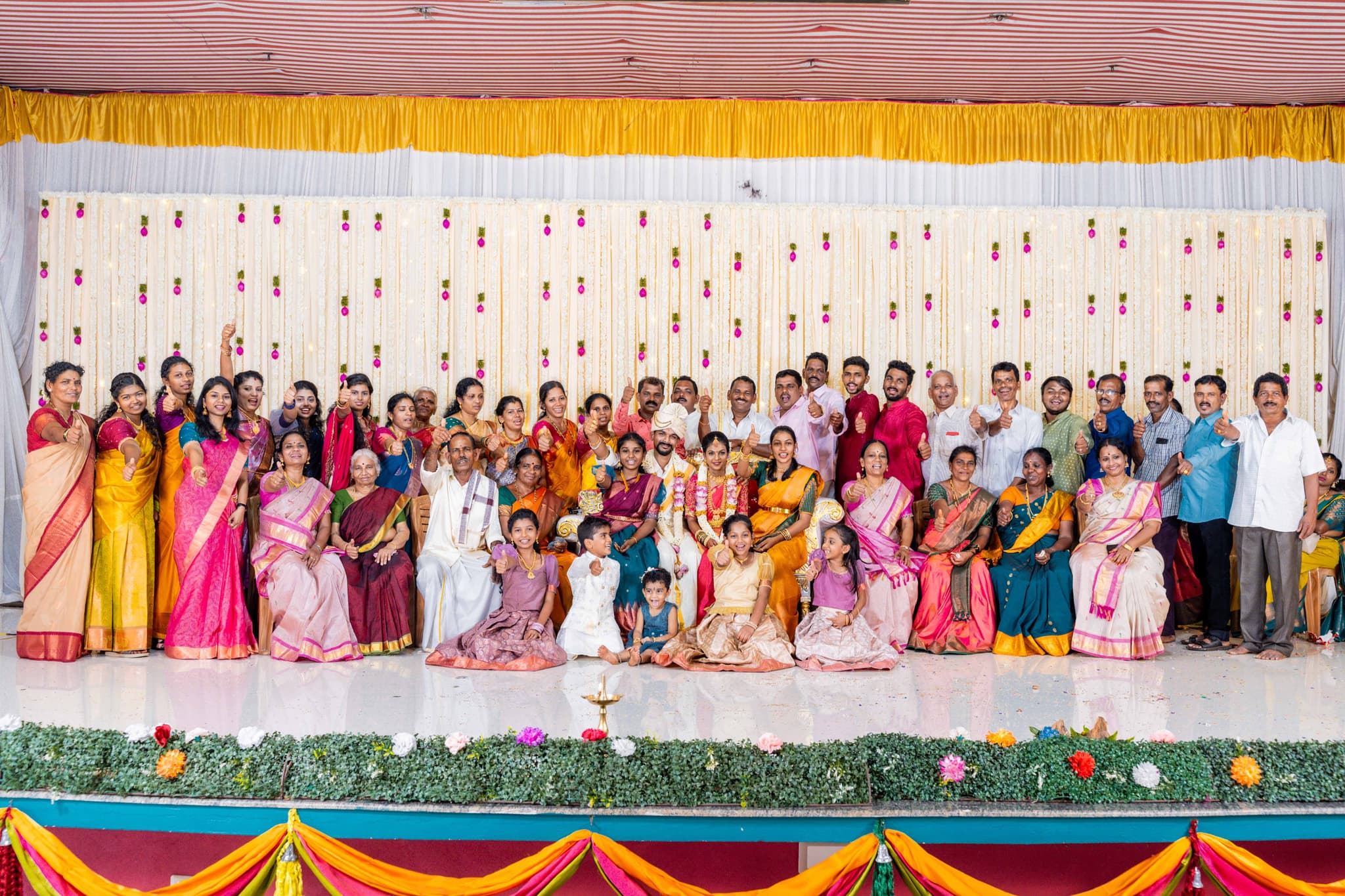 Traditional photography in Chennai - South Indian wedding family portrait with bride and groom surrounded by family members in colorful attire