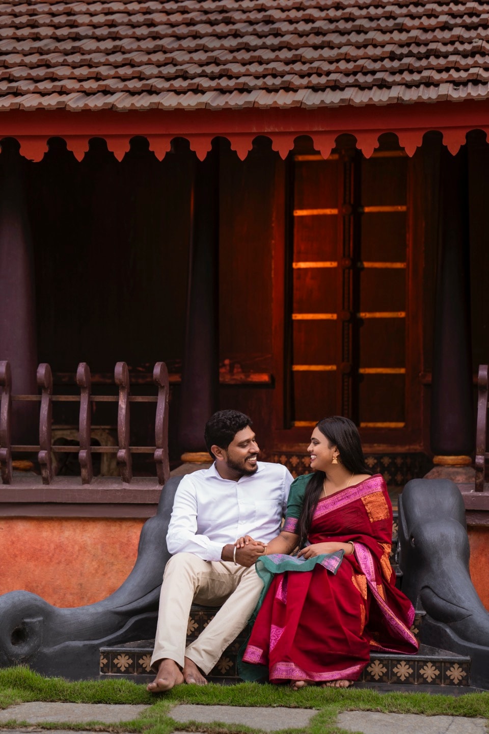South Indian couple sharing an intimate moment outside a traditional Kerala-style house, perfect for engagement story videos